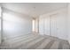 Neutral bedroom with plush carpeting, double closet doors and a bright window provides a clean space at 14739 W El Cortez Pl, Surprise, AZ 85387