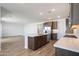 An island, stainless appliances, recessed lighting, hardwood floors, and plentiful counter space define this modern kitchen at 14739 W El Cortez Pl, Surprise, AZ 85387