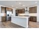 Modern kitchen with wood flooring, stainless steel appliances, an island with a sink, and recessed lighting at 14739 W El Cortez Pl, Surprise, AZ 85387