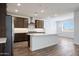 Kitchen showcasing an island with sink, stainless appliances, recessed lights, and hardwood flooring at 14739 W El Cortez Pl, Surprise, AZ 85387