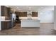 Kitchen area featuring an island with a sink, stainless steel appliances, hardwood flooring, and recessed lighting at 14739 W El Cortez Pl, Surprise, AZ 85387