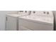 Close up of white, front-loading Whirlpool washer and dryer set featuring detailed control panels and sleek design at 14739 W El Cortez Pl, Surprise, AZ 85387