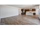 Spacious open concept living space featuring a view of the kitchen area and hardwood flooring at 14739 W El Cortez Pl, Surprise, AZ 85387