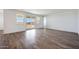 Spacious living room features wood-look tile flooring, abundant natural light, and backyard access at 14739 W El Cortez Pl, Surprise, AZ 85387