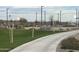 Community basketball court with walking path, green space, benches, and updated lights at 15911 W Montana De Oro Dr, Surprise, AZ 85387