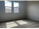 Bright bedroom with plush carpeting, and natural light from the two good-sized windows at 15911 W Montana De Oro Dr, Surprise, AZ 85387