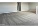 Large bedroom featuring neutral walls, carpet, and a staircase at 15911 W Montana De Oro Dr, Surprise, AZ 85387