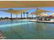Community pool featuring plenty of lounge chairs and a shallow splash pool for a resort-style outdoor experience at 15911 W Montana De Oro Dr, Surprise, AZ 85387
