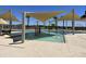 Community pool featuring a shallow water area with play features, and shaded seating for a fun community experience at 15911 W Montana De Oro Dr, Surprise, AZ 85387