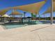 Community pool featuring a shallow water area with play features, and shaded seating for a fun community experience at 15911 W Montana De Oro Dr, Surprise, AZ 85387
