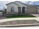 Attractive single-story house boasting a tile roof, artificial grass, and decorative rock landscaping at 15911 W Montana De Oro Dr, Surprise, AZ 85387