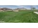 Beautifully landscaped green space featuring lush grass and walking path at 15911 W Montana De Oro Dr, Surprise, AZ 85387