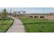 A scenic walking path winds through lush green space and under a bridge, creating a serene environment at 15911 W Montana De Oro Dr, Surprise, AZ 85387