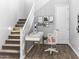 Cozy home office space under the stairs, complete with modern desk and chair at 15911 W Montana De Oro Dr, Surprise, AZ 85387