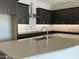 Stylish kitchen featuring dark cabinets, stainless steel range hood, and light countertops at 15911 W Montana De Oro Dr, Surprise, AZ 85387