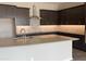 Modern kitchen features a large island, stylish cabinets, stainless steel appliances, and a decorative backsplash at 15911 W Montana De Oro Dr, Surprise, AZ 85387