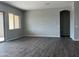 Spacious living room with neutral gray walls and vinyl floors at 15911 W Montana De Oro Dr, Surprise, AZ 85387