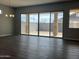Spacious living room with wood floors and sliding glass doors that offer ample natural light at 15911 W Montana De Oro Dr, Surprise, AZ 85387