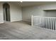 Spacious loft area featuring neutral walls and carpet, and a white railing at 15911 W Montana De Oro Dr, Surprise, AZ 85387