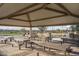 An outdoor seating area offers picnic tables and shade, perfect for enjoying outdoor meals at 15911 W Montana De Oro Dr, Surprise, AZ 85387