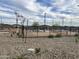 Pickle ball court with fencing, walking paths, benches, updated lighting, and community desert landscaping at 15911 W Montana De Oro Dr, Surprise, AZ 85387