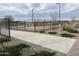Community pickleball court surrounded by landscaping and a black fence at 15911 W Montana De Oro Dr, Surprise, AZ 85387