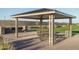 Enjoy outdoor dining at the covered picnic area, complete with a built-in grill and landscaping at 15911 W Montana De Oro Dr, Surprise, AZ 85387