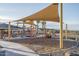 Community playground featuring swings and shade, providing a fun space for children to play at 15911 W Montana De Oro Dr, Surprise, AZ 85387