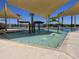 Resort-style pool featuring a colorful splash pad and sunshade structures at 15911 W Montana De Oro Dr, Surprise, AZ 85387
