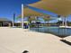 Community pool area with shaded structures, plenty of seating, and a water feature for  at 15911 W Montana De Oro Dr, Surprise, AZ 85387