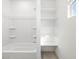 Bathroom showing shower-tub combo and built-in shelves at 16077 W Remuda Dr, Surprise, AZ 85387