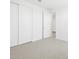 This bedroom features neutral carpet and a large closet, perfect for storage at 16077 W Remuda Dr, Surprise, AZ 85387