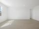 Well lit empty bedroom with tile flooring at 16077 W Remuda Dr, Surprise, AZ 85387