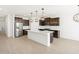 An open-concept kitchen featuring a large island, stainless steel appliances, and ample counter space at 16077 W Remuda Dr, Surprise, AZ 85387