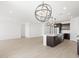 Modern kitchen with white countertops, stainless steel appliances, and stylish pendant lighting at 16077 W Remuda Dr, Surprise, AZ 85387