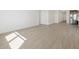 Spacious open-concept living room with tile flooring flowing into the kitchen at 16077 W Remuda Dr, Surprise, AZ 85387