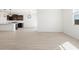 Open-concept kitchen and living area featuring tile floors and stainless appliances at 16077 W Remuda Dr, Surprise, AZ 85387