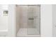 Bright walk in shower features tiled walls, glass doors, and chrome hardware at 16077 W Remuda Dr, Surprise, AZ 85387