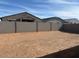 Large dirt backyard with block wall and partial views of the home exterior at 16080 W Prickly Pear Trl, Surprise, AZ 85387