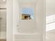 Bathroom featuring a large soaking tub, white walls, and a window at 16080 W Prickly Pear Trl, Surprise, AZ 85387