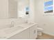 Bathroom featuring double sink vanity, wood look flooring, and bright natural light at 16080 W Prickly Pear Trl, Surprise, AZ 85387