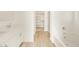 Bright bathroom with new tile floors, white cabinets, and double sinks at 16080 W Prickly Pear Trl, Surprise, AZ 85387