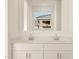 Bathroom vanity with double sinks, modern fixtures and neutral colored walls at 16080 W Prickly Pear Trl, Surprise, AZ 85387