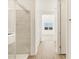 Spa-like bathroom with glass shower enclosure and neutral ceramic tiles at 16080 W Prickly Pear Trl, Surprise, AZ 85387