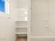 Bright bathroom with built in shelves next to the tub and shower at 16080 W Prickly Pear Trl, Surprise, AZ 85387