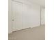Bedroom featuring large sliding closet doors and neutral carpeting at 16080 W Prickly Pear Trl, Surprise, AZ 85387