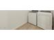 Laundry room with modern washer and dryer on new tile floors at 16080 W Prickly Pear Trl, Surprise, AZ 85387