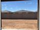 View of an empty backyard with block wall and potential for landscaping at 16081 W Remuda Dr, Surprise, AZ 85387