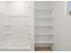 Bright bathroom featuring built-in shelves and a clean, white shower/tub combo at 16081 W Remuda Dr, Surprise, AZ 85387