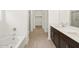 Bathroom featuring double sink vanity and a separate bathtub and shower at 16081 W Remuda Dr, Surprise, AZ 85387